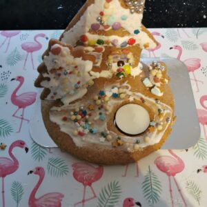 a 2D gingerbread house with a candle
